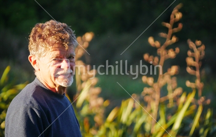 Single man with flax in background