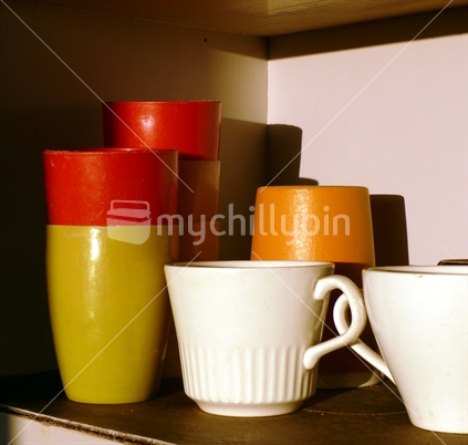 Retro plastic mugs, beer mug and cups in cupboard
