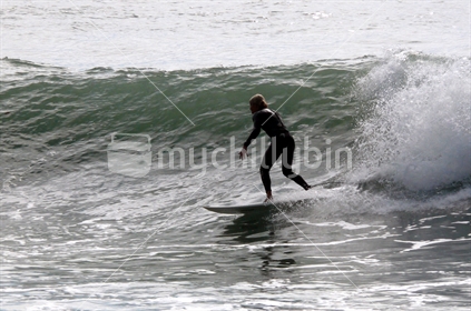 Surfer catches a wave
