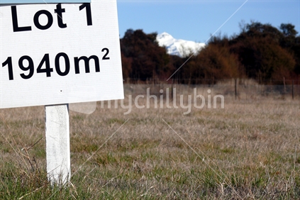 Prime real estate. For sale sign on paddock in front of Southern Alps