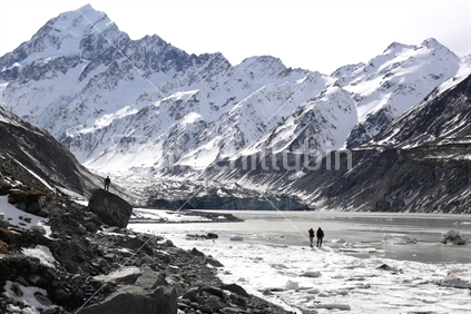 Two people walking towards Hooker glacier and Mt Cook, New Zealand