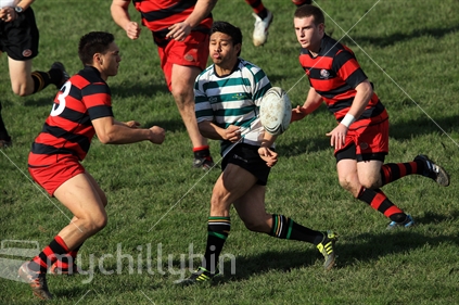 A rugby player passes during a rugby game in Wellington.