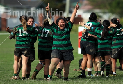 Rugby players celebrate after winning a women's rugby game in Wellington.