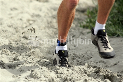 A competitor runs along the sand, Coast to Coast, Christchurch, New Zealand