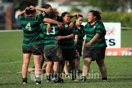 Rugby players celebrate after winning a women's rugby game in Wellington.