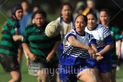 A rugby player passes during a women's rugby game in Wellington.