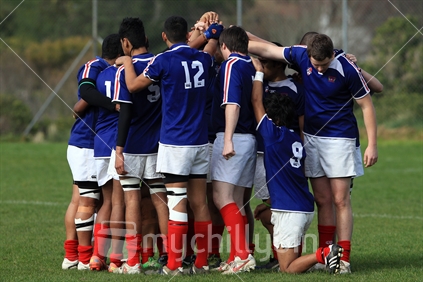 A rugby players form a huddle during a rugby game in Wellington.