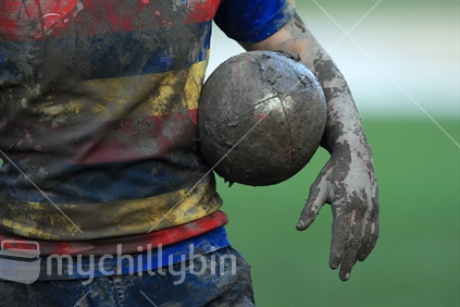 A player carries a ball during a rugby game in Wellington