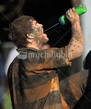 A player takes a drink of water during a rugby game in Wellington