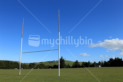 A rural rugby ball and goalposts.