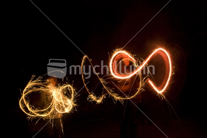 Kids painting with sparklers in the dark