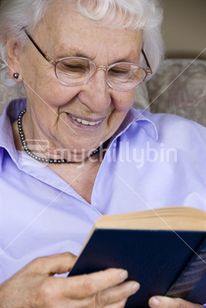 Elderly lady reading a book
