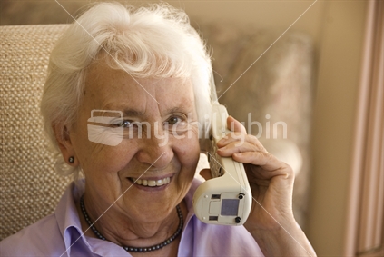 Elderly lady on the phone smiling