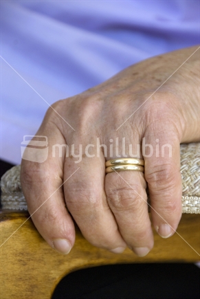 A widows hand with her and her husbands wedding rings