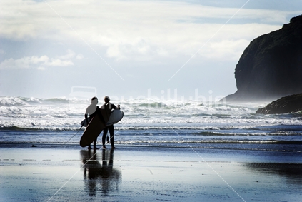 Surfers at Piha beach in west Auckland