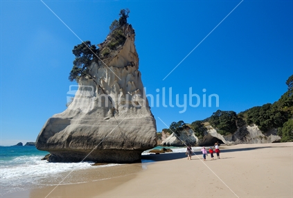 Family walking on beach at Cathedral Cove, Coromandel