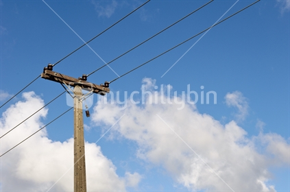 Power pole against blue sky