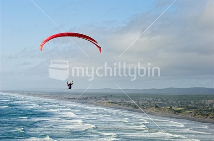 Paragliding high over Muriwai surf beach