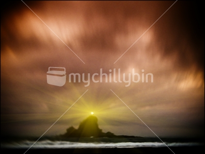 An atmospheric artistic evocative shot of Whatipu beach lighthouse on the rock at sunrise (soft focus)