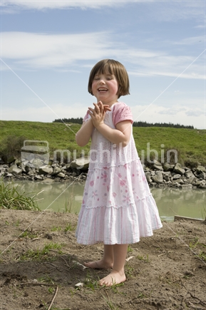 4 year old girl with clasped hands playing