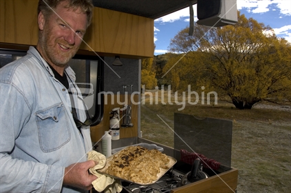 Man making scones in his motorhome