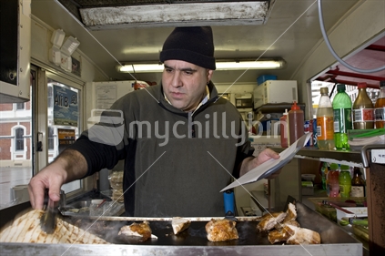 Lebanese man living in New Zealand cooking in mobile kebab kitchen