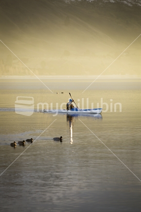 kayaker on lake wanaka at sunset