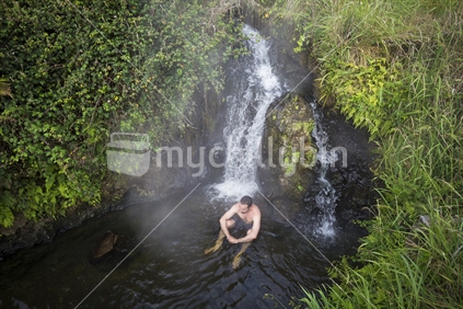 Man in free thermal hot spring Taupo