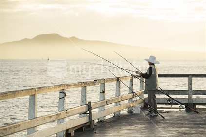 Lady fishing off Auckland wharf