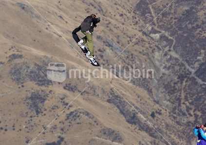 Snowboarder doing a grab at Cardrona