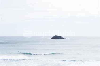 Surfers and Distant Rock