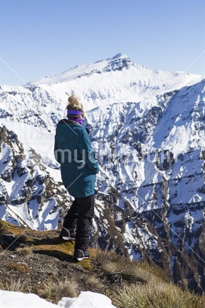 Woman looking toward snow capped mountain
