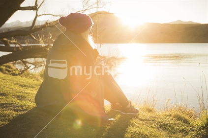 Woman watching sunset at Lake Hayes