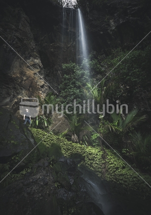 Man observing the top of a Waitakere waterfall