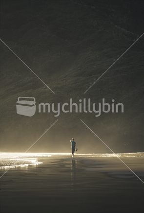 Person walking on Auckland beach