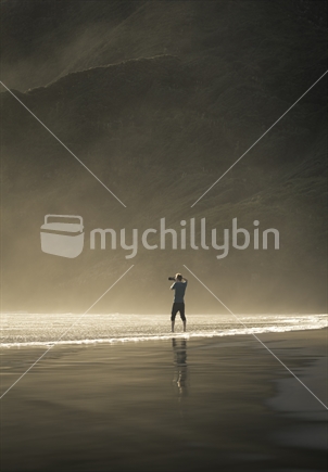 man taking photo on Auckland beach