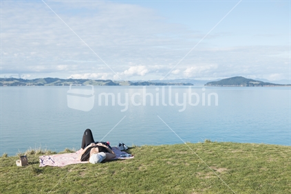 Young Woman relaxing on green grass