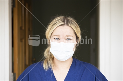 Young woman nurse with a protective mask