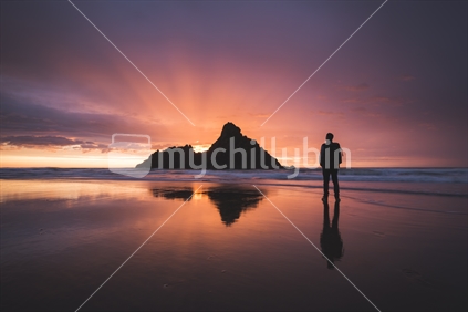 Man watching beautiful sunset, West Auckland