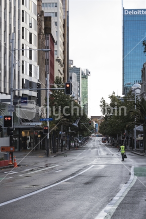 One worker walks along Queen Street Auckland city