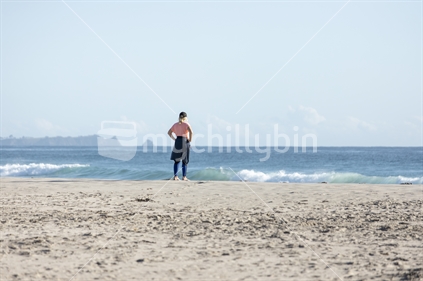Woman on beach looking at ocean