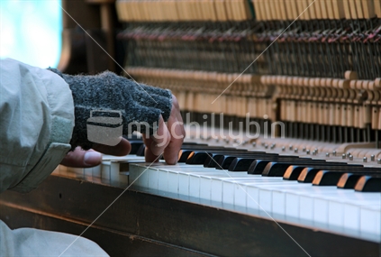 Male busker playing piano. New Zealand.