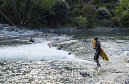 Lining up to ride the man made wave at the Hawea River, Otago