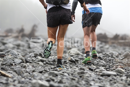Splash - two runners, running off road into the mist