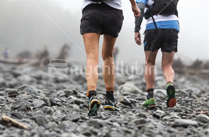 Two runners, running off road into the mist