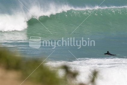 Surfer at Te Oka Bay banks peninsula