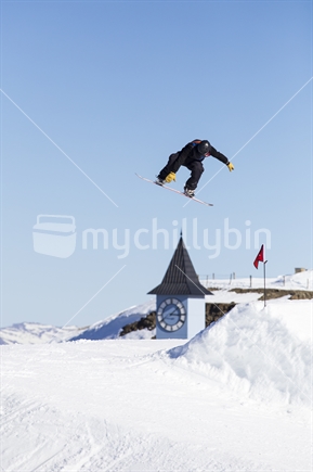Snowboarder jumping at ski field