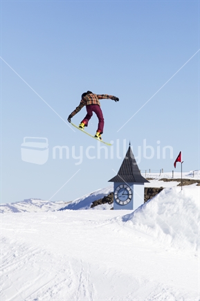 snowboarder jumping at ski area
