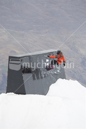 Male snowboarder performs a jump