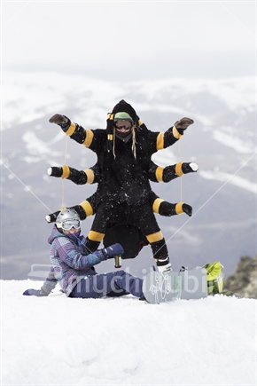 Man dressed in spider costume up ski field